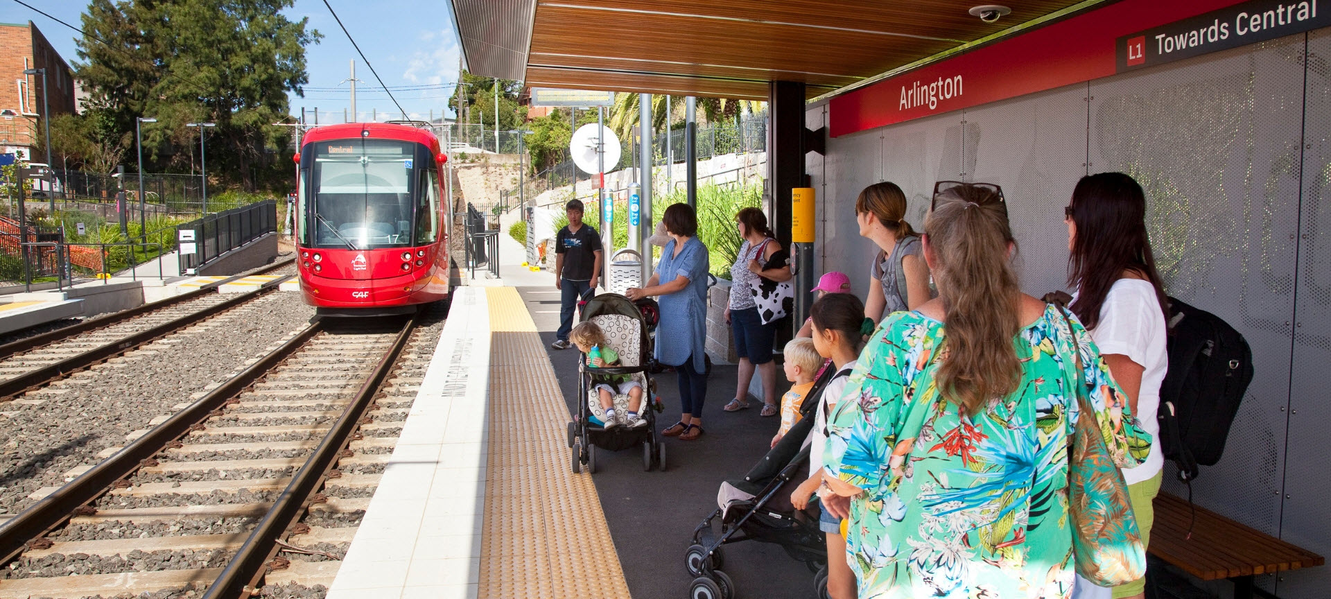 People wait for the Sydney Light Rail at Darlington.